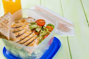 Lunch box with salad and chicken